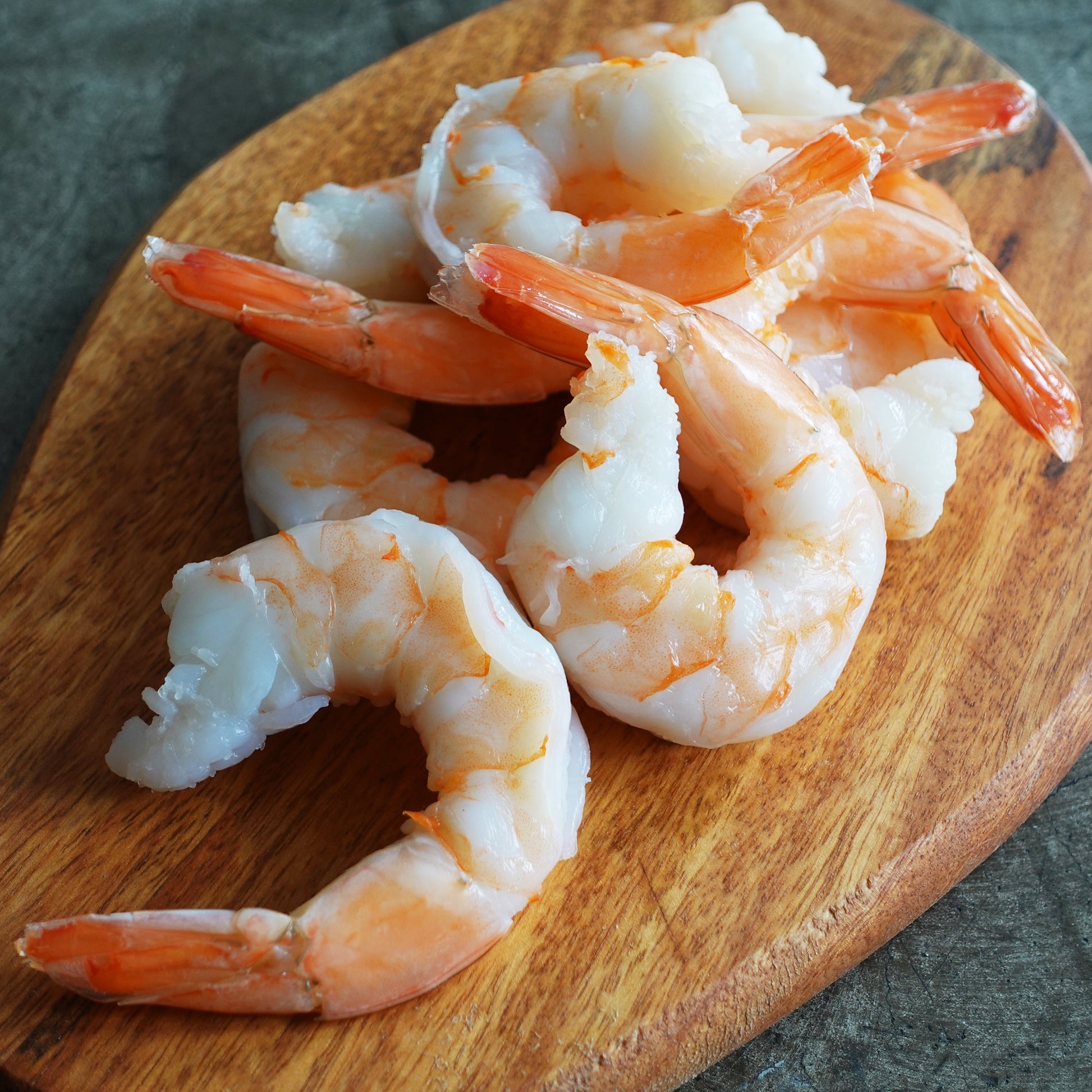 Shrimp cocktail on top of a wooden board