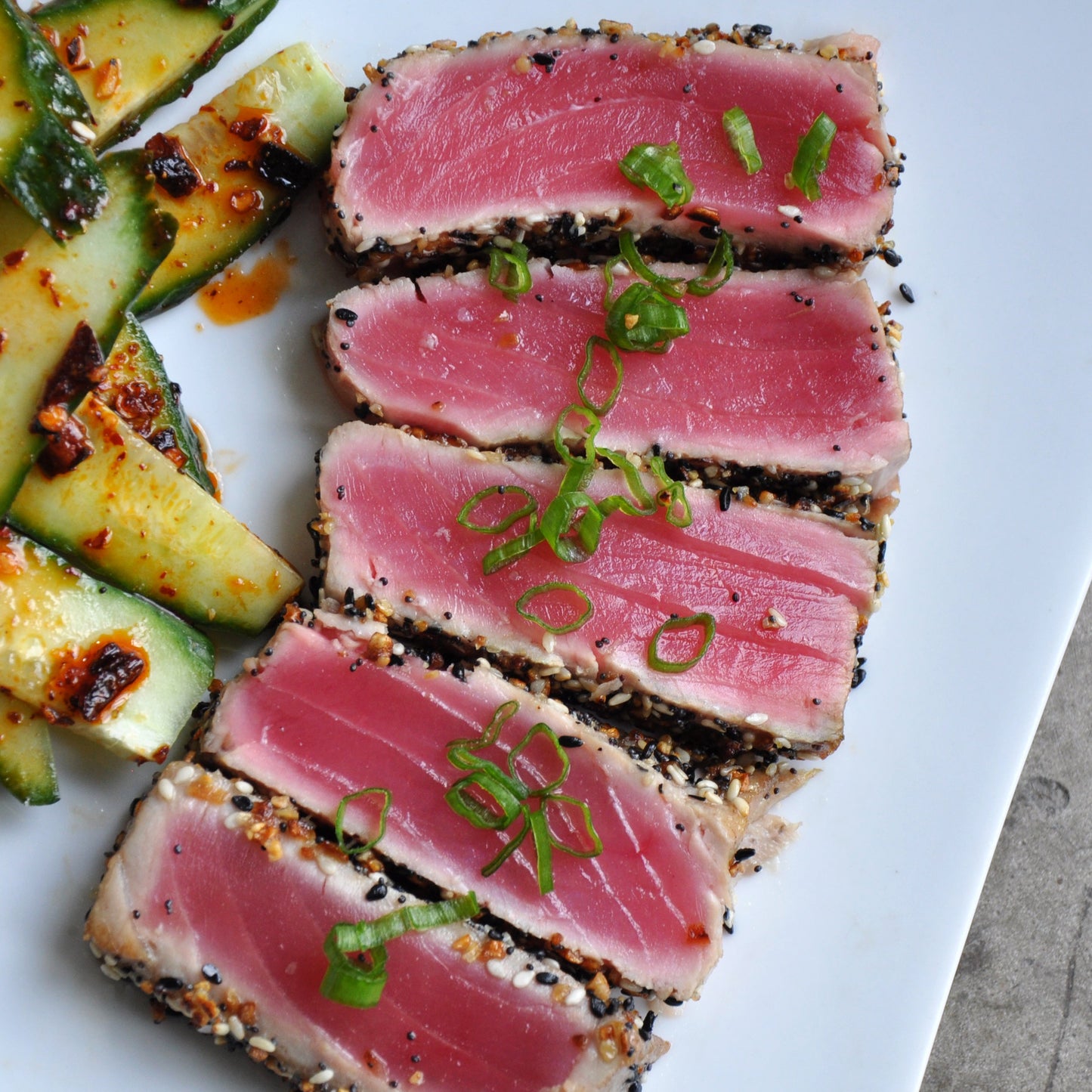 Yellowfin tuna sliced into pieces on a white plate