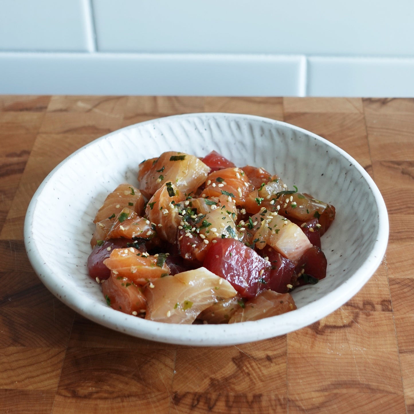 a medium shot of rainbow poke in a white bowl